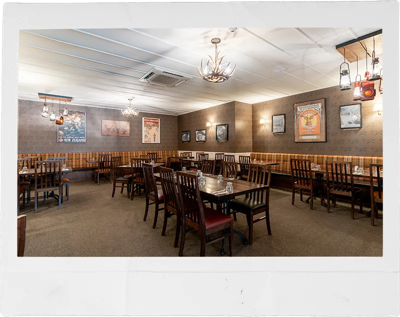 a restaurant with tables and chairs and a chandelier
