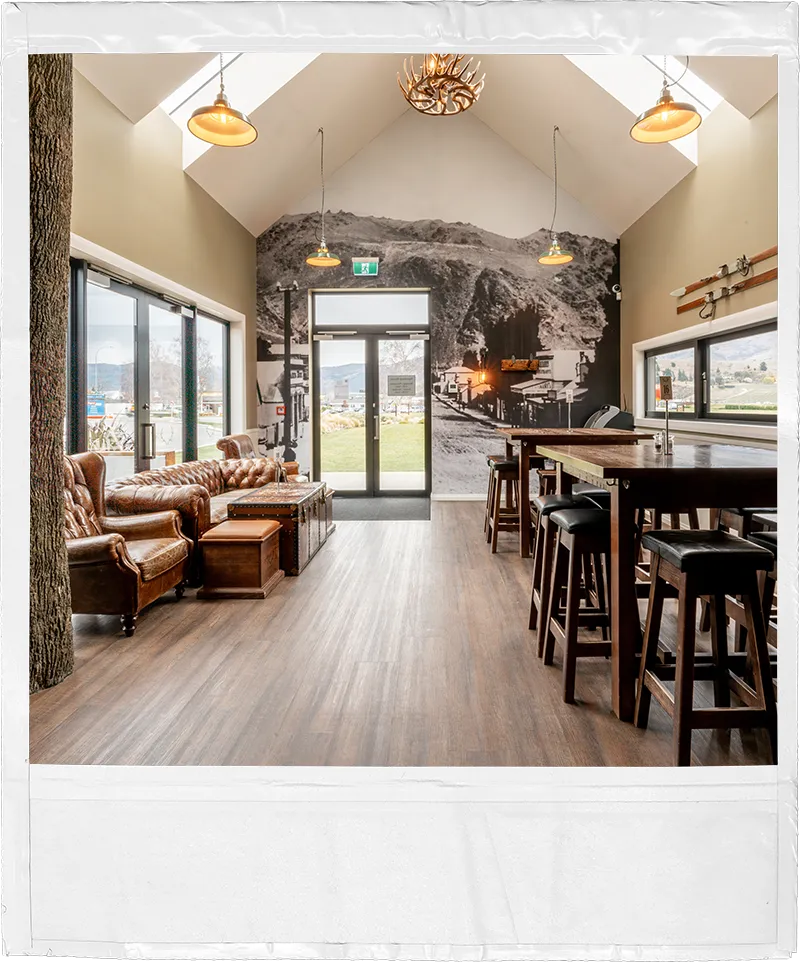 a dining room with a couch a table and chairs at the five stags crowmell